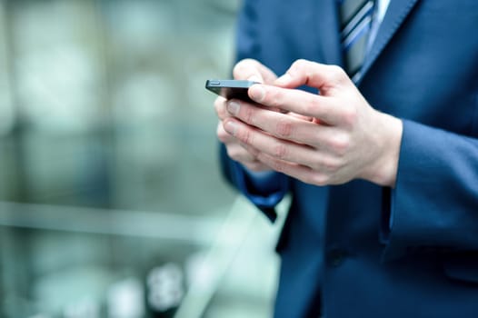 Businessman hand using a mobile phone at outdoors
