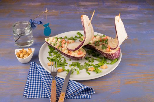 Sailboat salad on an eggplant vessel, kid food