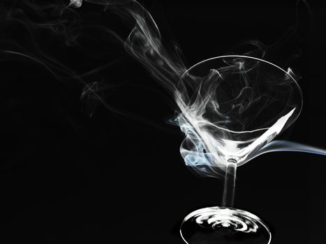 cocktail glass with smoke over black background