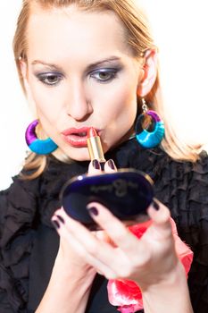 Young beautiful woman applying fashionable colorful party make-up.