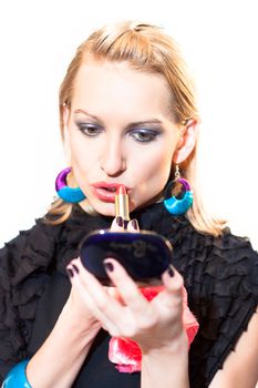 Young beautiful woman applying fashionable colorful party make-up.