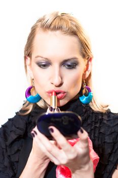 Young beautiful woman applying fashionable colorful party make-up.