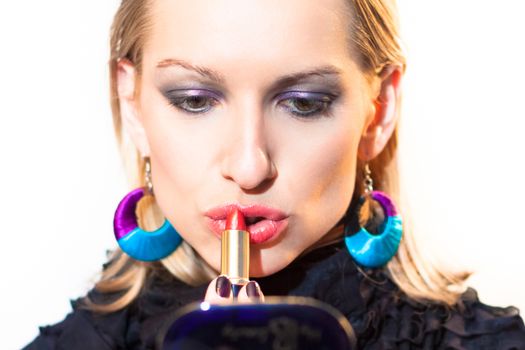 Young beautiful woman applying fashionable colorful party make-up.