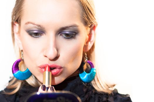 Young beautiful woman applying fashionable colorful party make-up.