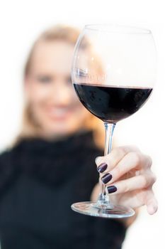 Business woman toasting with a glass of red wine.