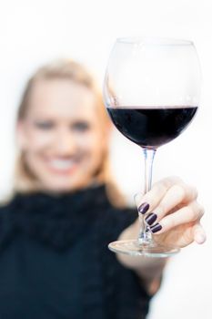 Business woman toasting with a glass of red wine.