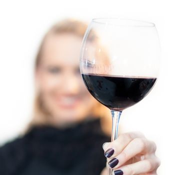 Business woman toasting with a glass of red wine.