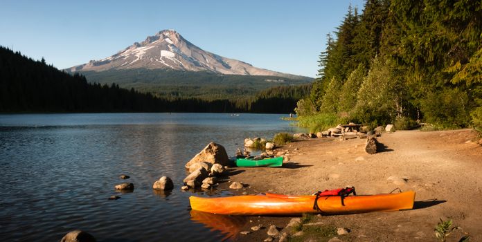 Kayaks beached on the shore of an Oregon Lake