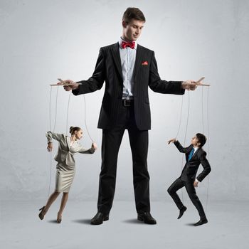 puppeteer keeps business people puppets, concept control business