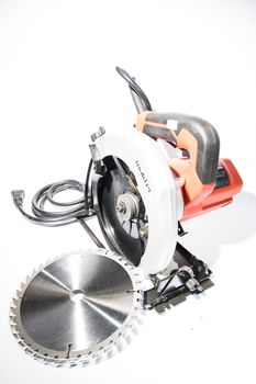 Electric circular saw on white background