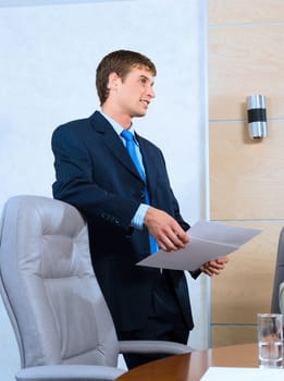 image of a businessman in the office with business papers