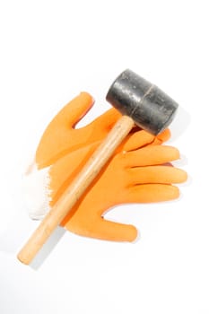 Construction gloves and hammer on white background.