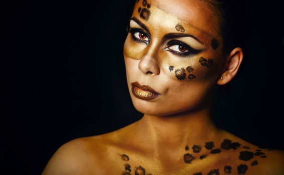 Attractive young girl with makeup wild leopard close-up portrait