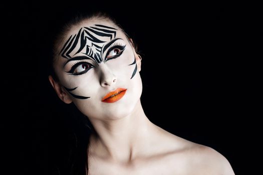 Attractive young girl with make-up of wild zebra close-up portrait