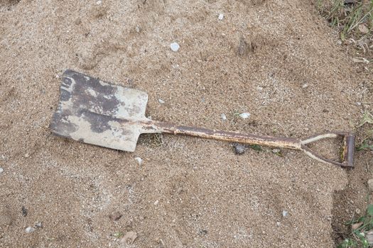 Shovel on a pile of sand in construction.