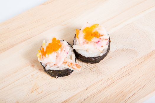 Sushi Crab shrimp eggs rolls on wooden floors.
