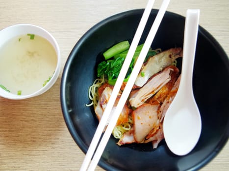 Chinese egg noodles with red pork in hot soup 