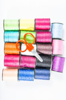 Colorful sewing threads on white.
