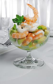Shrimp with avocado yogurt and red pepper in a glass