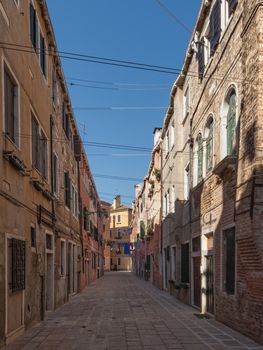 Small street with colourful buildings in Venice, Italy
