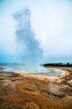 Eruption of Strokkur Geyser in Iceland. Vertical view