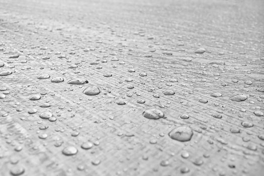 Drops of water on the muddy surface of the protective roof of the building materials-Gidrobarer