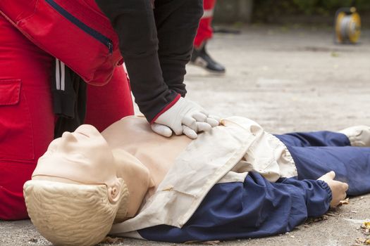 Paramedic demonstrates CPR on dummy