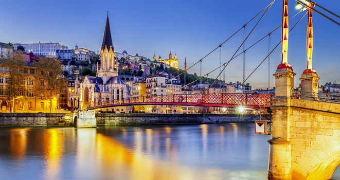 night view from St Georges footbridge in Lyon city with Fourviere cathedral, France