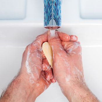 Man washing his hands with soap