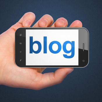SEO web design concept: hand holding smartphone with word Blog on display. Mobile smart phone on Blue background, 3d render