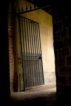 iron gate exit from a dark mysterious alleyway