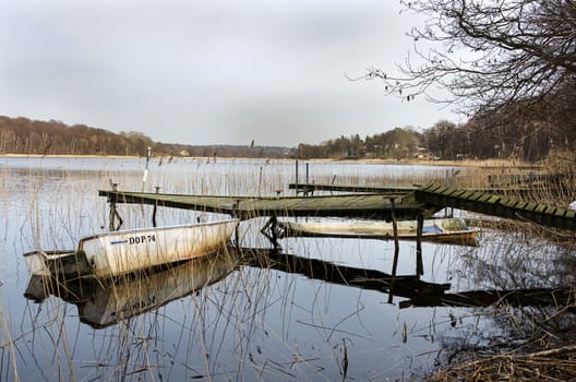 old dilapidated bridge with two old boats
