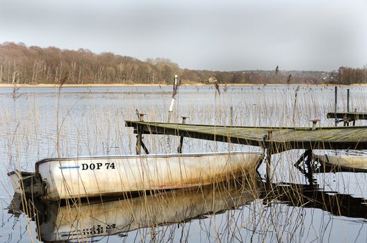 old dilapidated bridge with one old boats
