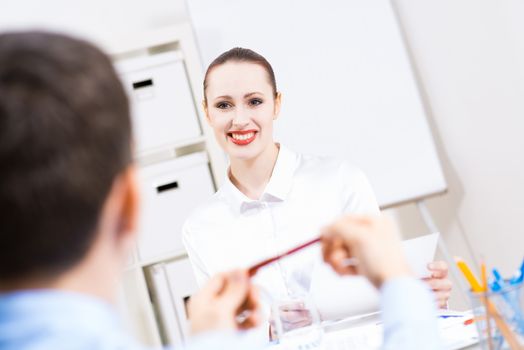 business woman holding an interview with a man in the office