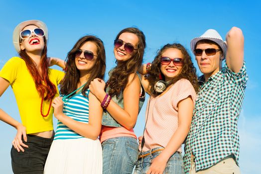 group of young people wearing sunglasses and hats hugging and standing in a row, spending time with friends