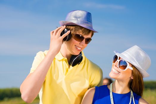 young couple standing on the road, having fun with friends