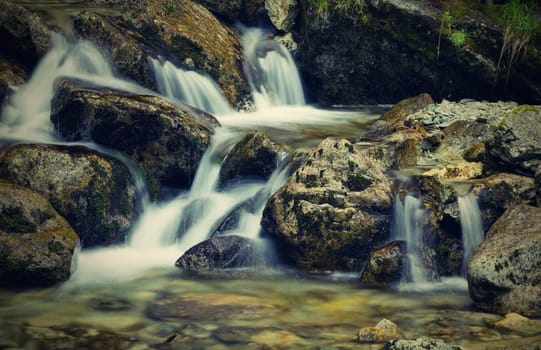 Nice detail of small cascade with mossy stones 