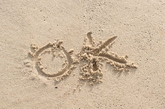 OK - sand writing concept on the beach
