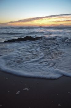 Beach, water under sunset scene in portugal