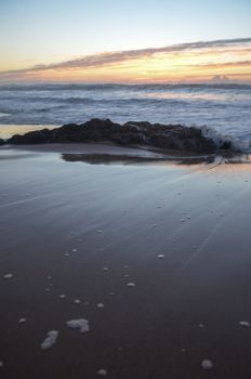 Beach, water under sunset scene in portugal