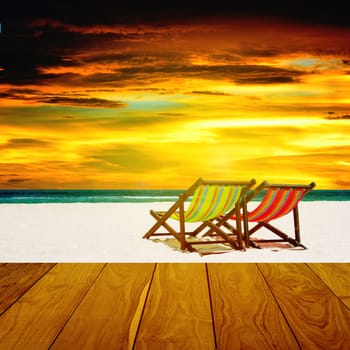 Beach chairs with summer sea and sunset sky background