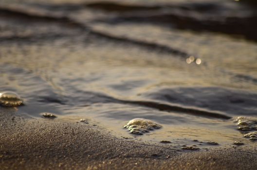 Beach, water under sunset scene in portugal