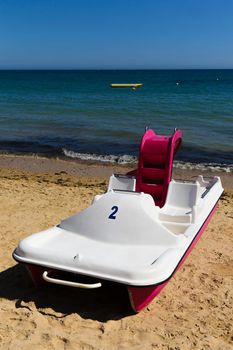 Pink pedalo for rent on the beach