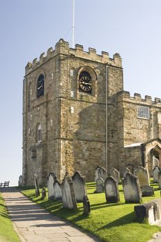 St Mary's Church, Whitby, North Yorkshire with a view of the ancient stone medieval clock tower and graveyard where Bram Stokers film Dracula was filmed