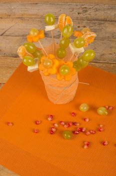 Fruit cocktail  on skewers inside a glass, kid food