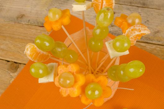 Assorted fruit and cheese decorated to make it attractive for kids
