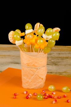 Fruit cocktail  on skewers inside a glass, kid food