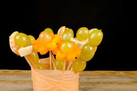 Assorted fruit and cheese decorated to make it attractive for kids
