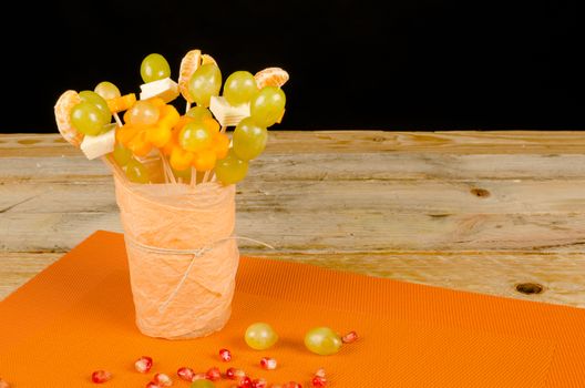 Assorted fruit and cheese decorated to make it attractive for kids
