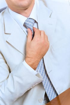 image of businessman without face straightens tie yourself